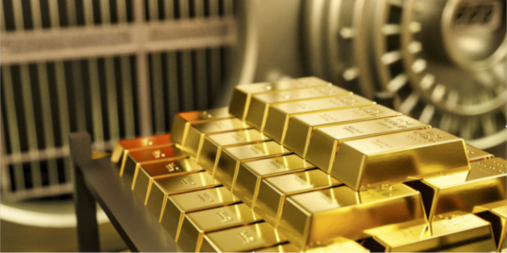 Storing Precious Metals Various bars of gold in front of a safe.